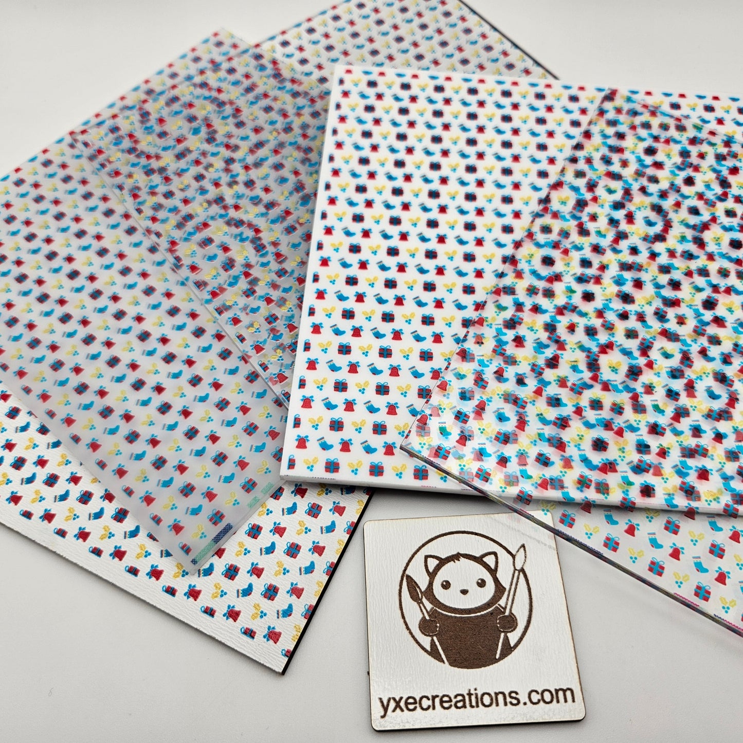 Colorful patterned sheets sheets with a logo and website text on a light gray background