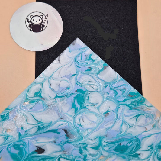 Marbled acrylic with blue and white patterns on a beige surface