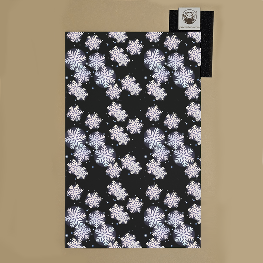 Black towel with white snowflake pattern on a beige background