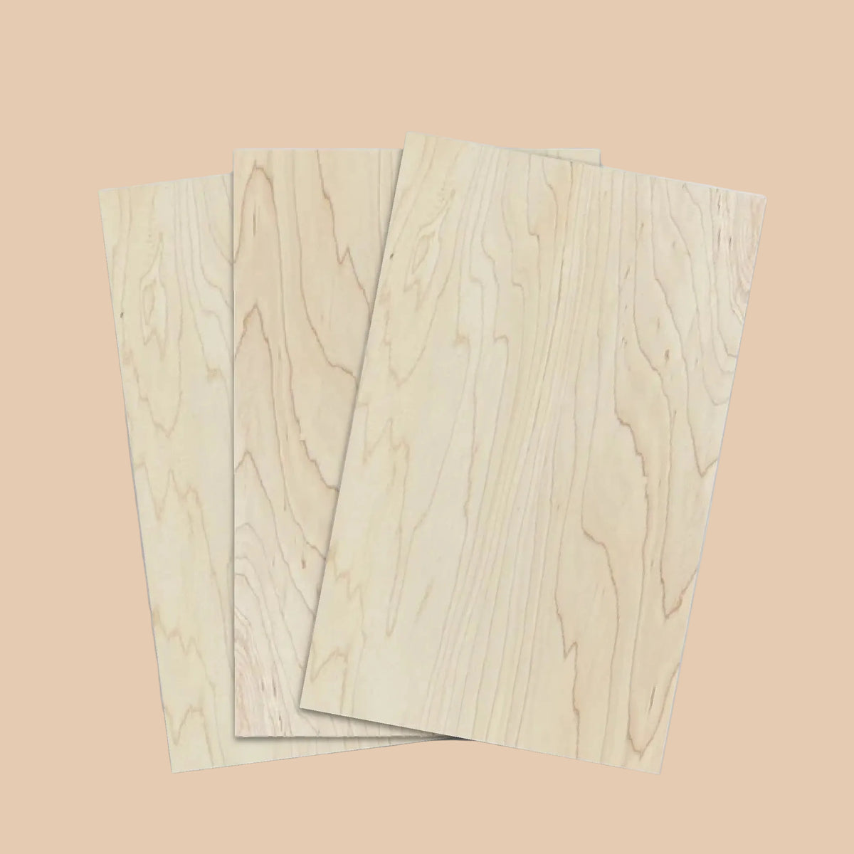 Three rectangular light wood panels with visible natural grain patterns, arranged in a slightly overlapping stack on a plain white background.