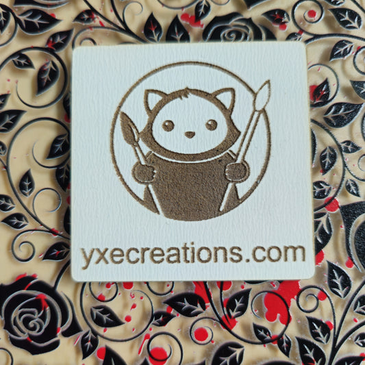 Card with a cute character design and 'yxecreations.com' text on a decorative background with Black Roses and Red Paint