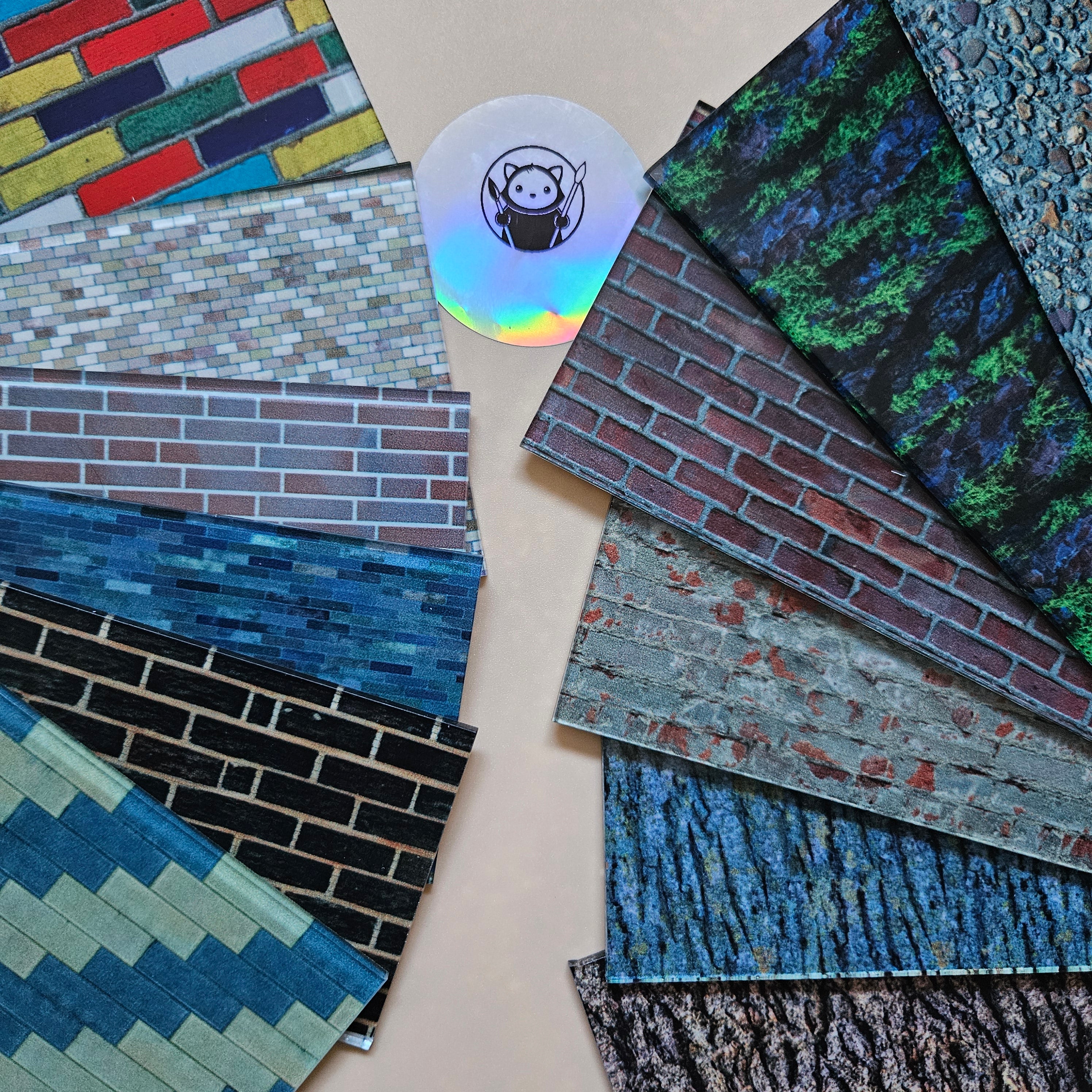 Collection of various textured tiles on a beige surface with a small logo in the center. Next Level Sheets