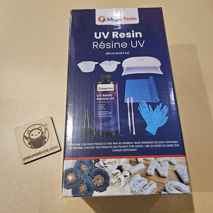 Box of UV Resin with resin bottle and tools on a beige background