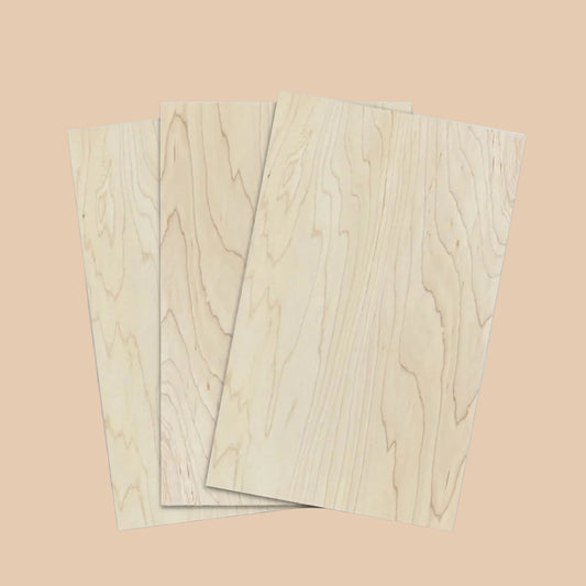 Three rectangular light wood panels with visible natural grain patterns, arranged in a slightly overlapping stack on a plain white background.