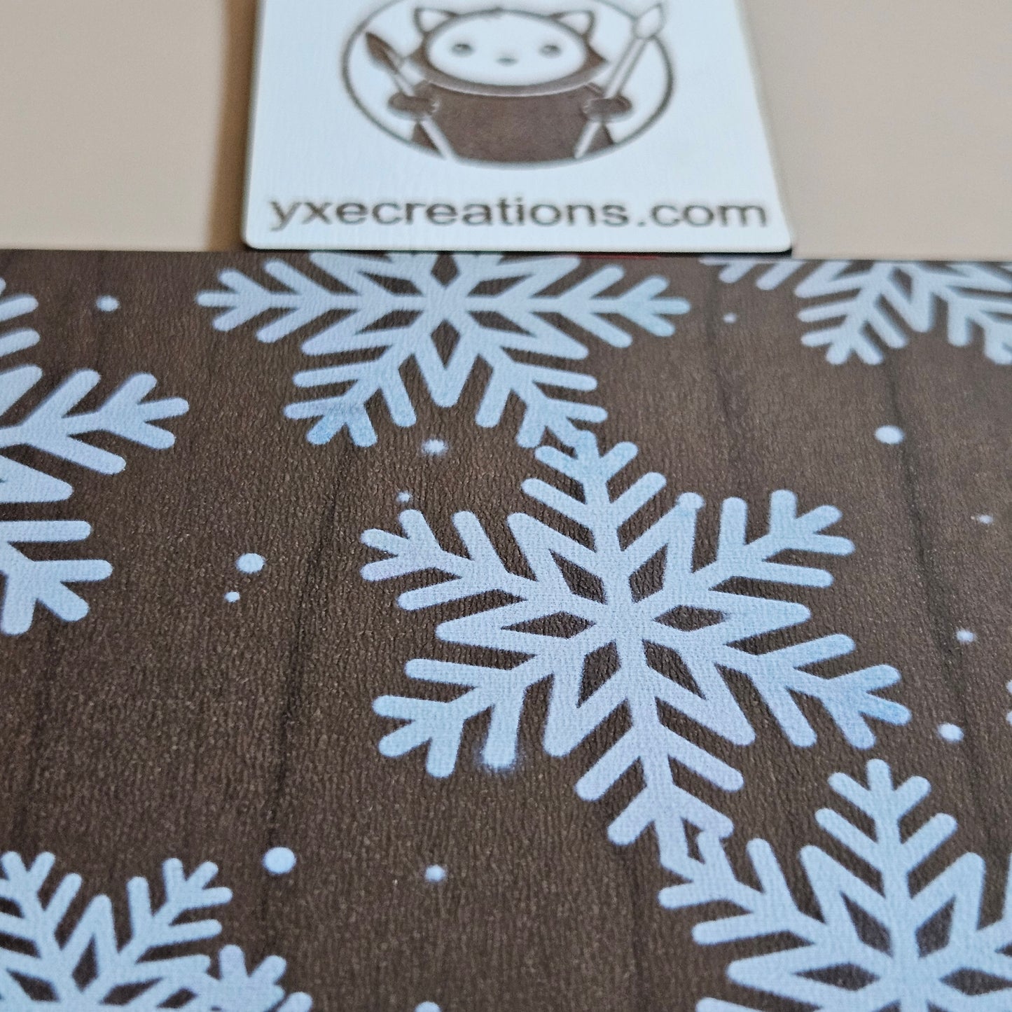 Brown Next Level Sheet Acrylic with white snowflake pattern and VYCE Creations logo.